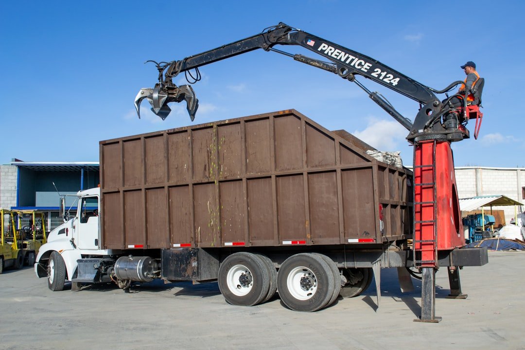 crane-truck-loading-debris-into-a-large-bin-mkn6zsztat4